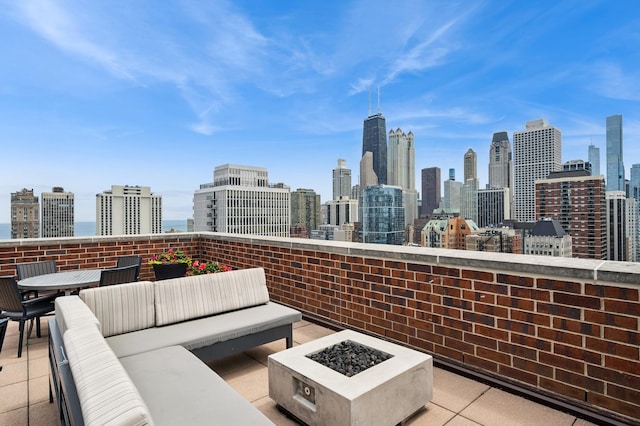 1250 N Dearborn St Unit 10B, Chicago, IL 60610 - view of patio / terrace with a skyline view and an outdoor living space with a fire pit