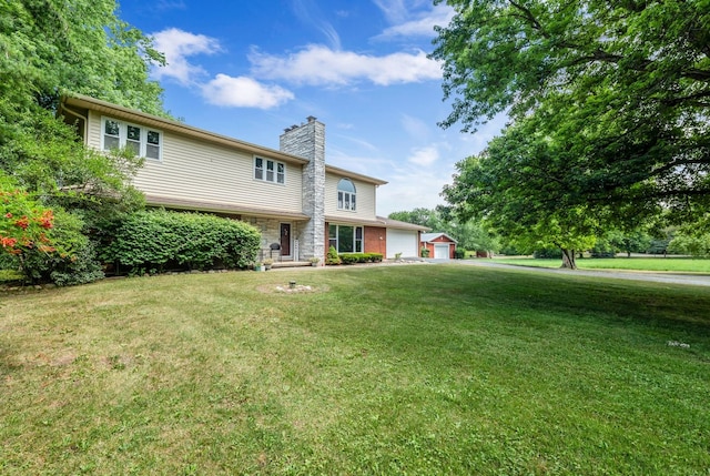 9822 W Pauling Rd, Monee, IL 60449 - view of front of home with a chimney, a garage, a front lawn, and an outbuilding