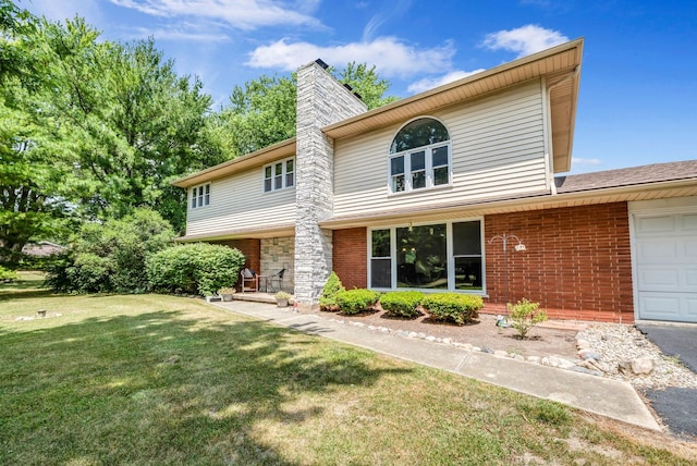 9822 W Pauling Rd, Monee, IL 60449 - view of front of property with an attached garage, a front lawn, brick siding, and a chimney