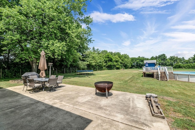 9822 W Pauling Rd, Monee, IL 60449 - view of patio with a trampoline, outdoor dining area, an outdoor pool, a wooden deck, and stairs