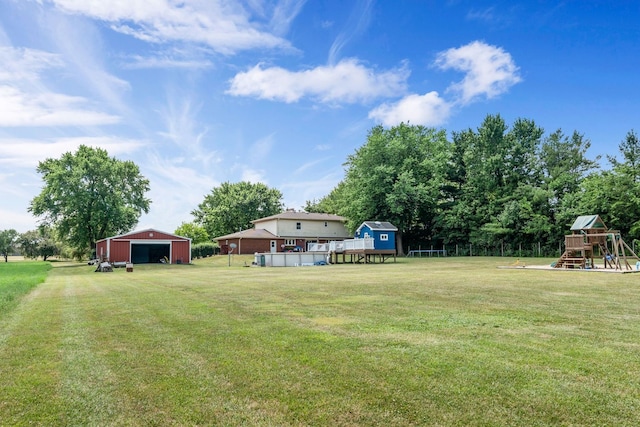 9822 W Pauling Rd, Monee, IL 60449 - view of grassy yard with a playground, an outdoor structure, and a detached garage