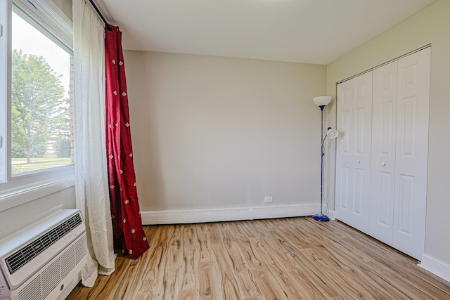 9562 Park Ln Unit 1D, Des Plaines, IL 60016 - unfurnished bedroom with light wood-style floors, a closet, and baseboard heating