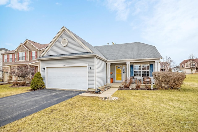 1075 Christine Ln, Antioch, IL 60002 - view of front of home featuring a garage, driveway, a porch, a front lawn, and roof with shingles
