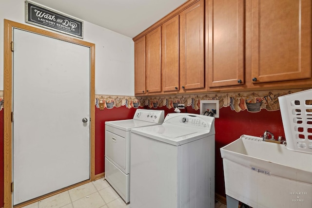 1075 Christine Ln, Antioch, IL 60002 - washroom featuring washer and clothes dryer, cabinet space, and light tile patterned flooring