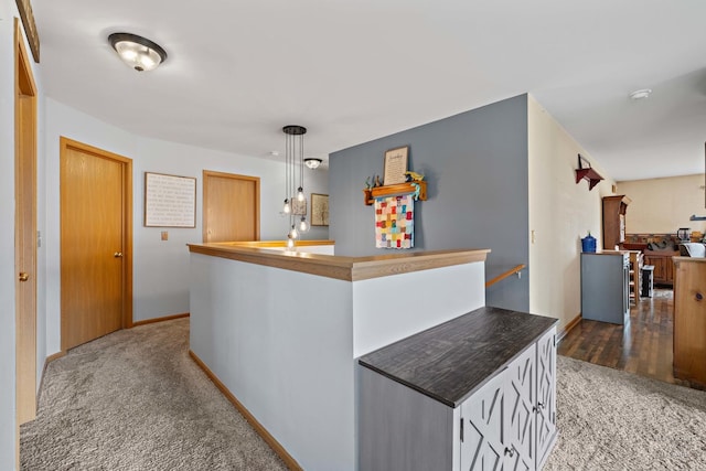1075 Christine Ln, Antioch, IL 60002 - kitchen with carpet, pendant lighting, and white cabinetry