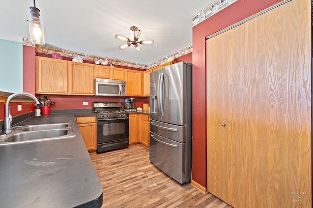 1075 Christine Ln, Antioch, IL 60002 - kitchen featuring appliances with stainless steel finishes, light wood finished floors, and dark countertops