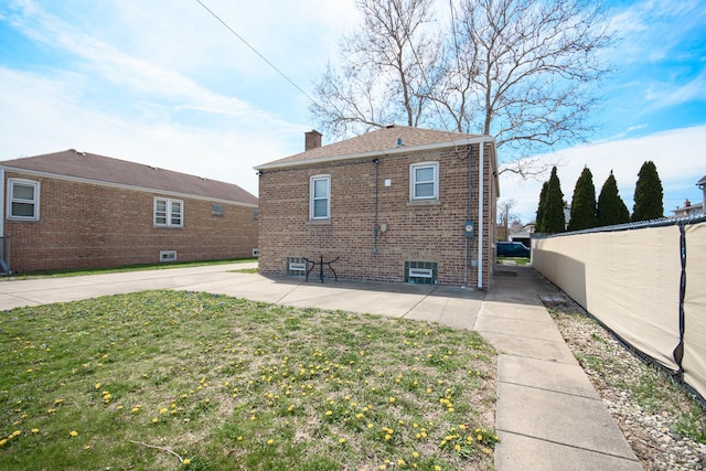 5533 S Menard Ave, Chicago, IL 60638 - rear view of house with brick siding, a chimney, and a patio area