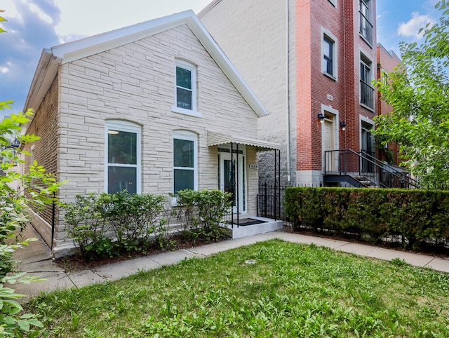 1406 N Artesian Ave, Chicago, IL 60622 - view of front of home with a front yard and stone siding