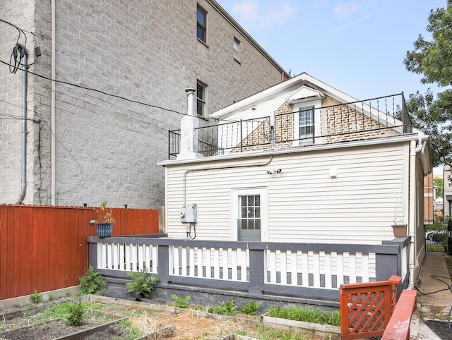1406 N Artesian Ave, Chicago, IL 60622 - rear view of property featuring a wooden deck, a vegetable garden, and a balcony