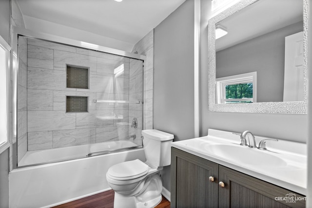 829 Liberty St, Aurora, IL 60505 - full bathroom with vanity, wood finished floors, and enclosed tub / shower combo