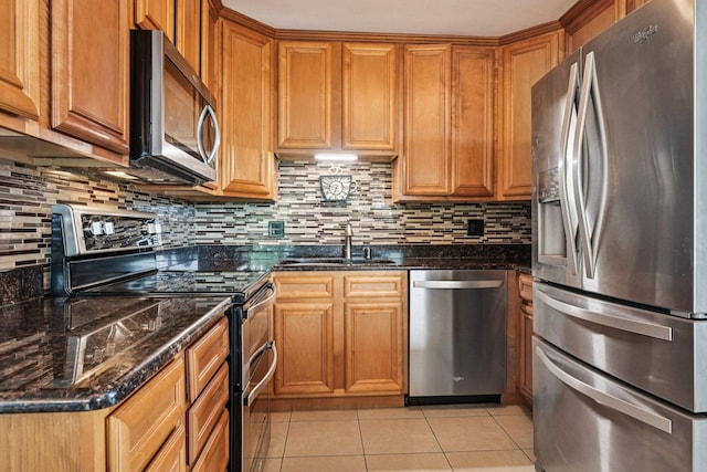101 Bar Harbour Rd Unit 5N, Schaumburg, IL 60193 - kitchen featuring appliances with stainless steel finishes, light tile patterned floors, and backsplash