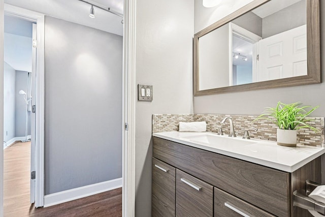 101 Bar Harbour Rd Unit 5N, Schaumburg, IL 60193 - bathroom with wood finished floors, vanity, backsplash, and rail lighting