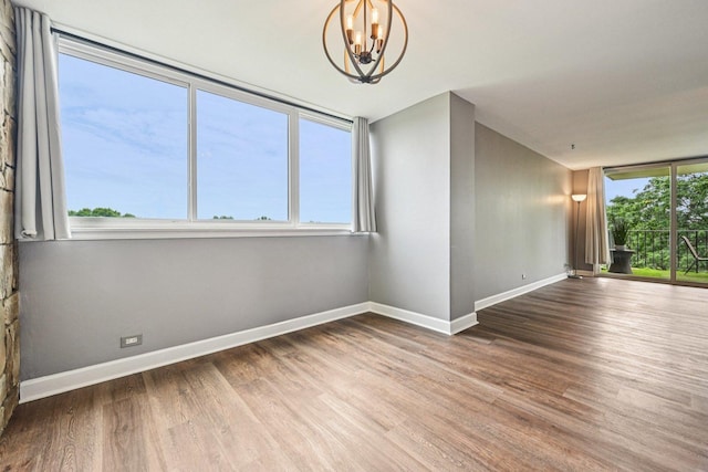 101 Bar Harbour Rd Unit 5N, Schaumburg, IL 60193 - unfurnished room with a chandelier and wood finished floors