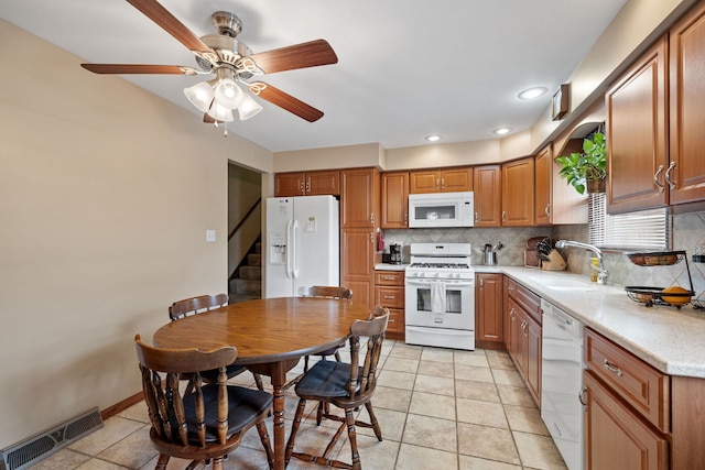 8424 Moody Ave, Burbank, IL 60459 - kitchen featuring white appliances, backsplash, light countertops, a ceiling fan, and brown cabinetry