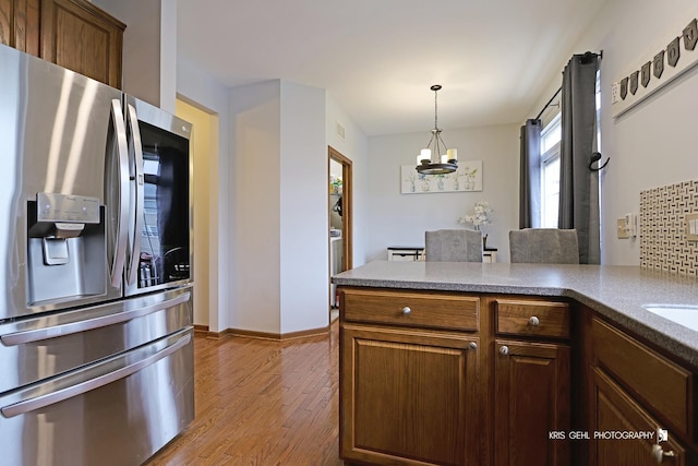 78 Thomas Ct, Grayslake, IL 60030 - kitchen featuring stainless steel fridge with ice dispenser, a chandelier, wood finished floors, hanging light fixtures, and a peninsula