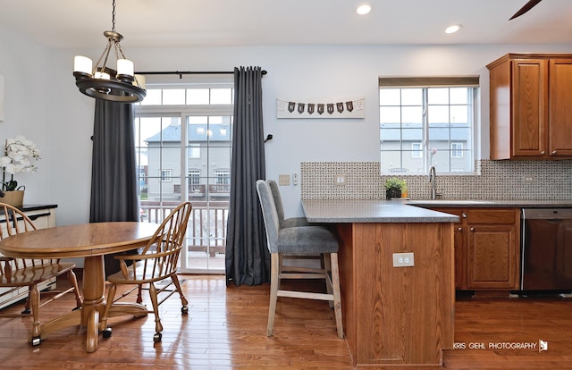78 Thomas Ct, Grayslake, IL 60030 - kitchen featuring dishwasher, brown cabinetry, healthy amount of natural light, a breakfast bar, and recessed lighting