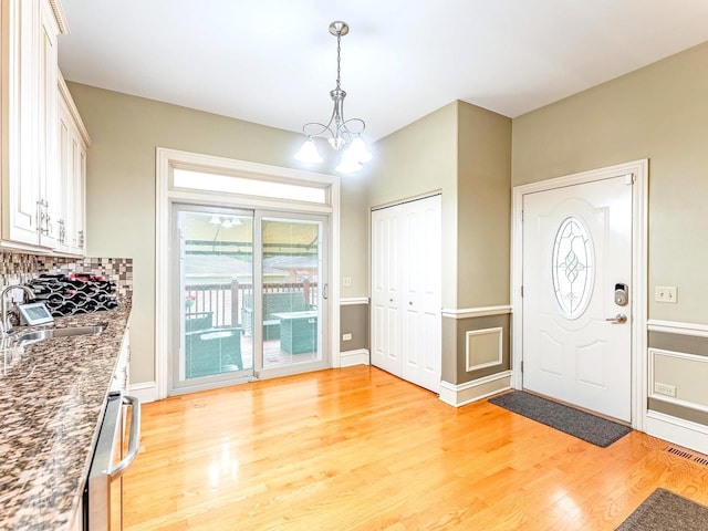 3139 Ridgeland Ave, Berwyn, IL 60402 - entryway with light wood-style flooring, plenty of natural light, and a chandelier