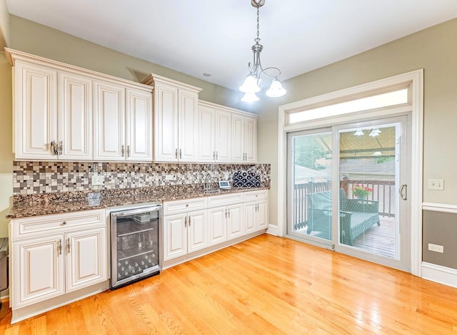 3139 Ridgeland Ave, Berwyn, IL 60402 - bar with wine cooler, a chandelier, backsplash, and light wood finished floors