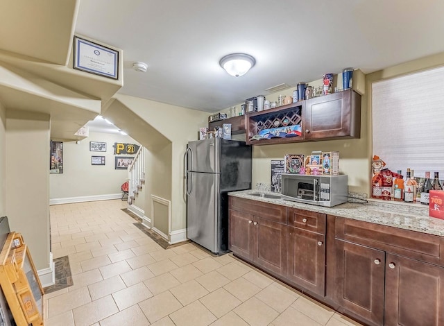 3139 Ridgeland Ave, Berwyn, IL 60402 - kitchen with appliances with stainless steel finishes, light stone counters, and light tile patterned floors