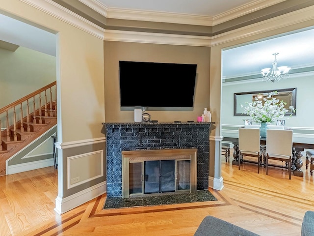 3139 Ridgeland Ave, Berwyn, IL 60402 - living room with stairs, a fireplace, crown molding, a chandelier, and wood finished floors