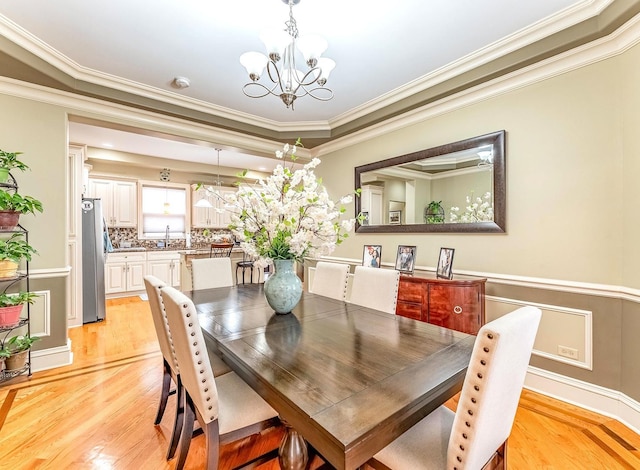 3139 Ridgeland Ave, Berwyn, IL 60402 - dining room featuring a chandelier, ornamental molding, and light wood-style flooring