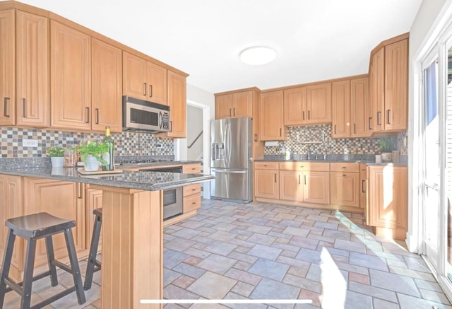 1933 Birch St, Des Plaines, IL 60018 - kitchen with stainless steel appliances, a peninsula, a breakfast bar area, light stone finish floors, and backsplash