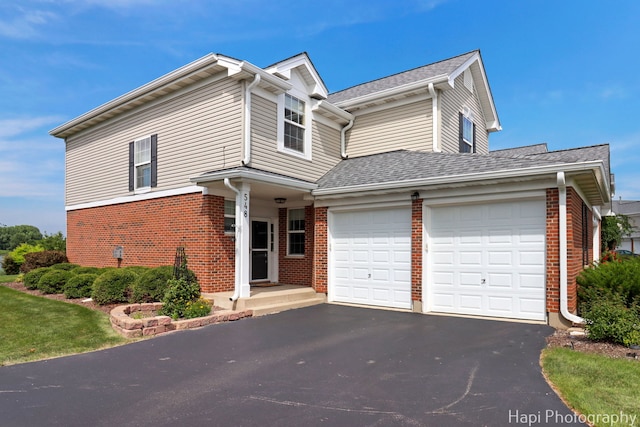 548 Legend Ln, Mchenry, IL 60050 - view of front facade with brick siding, driveway, an attached garage, and a shingled roof