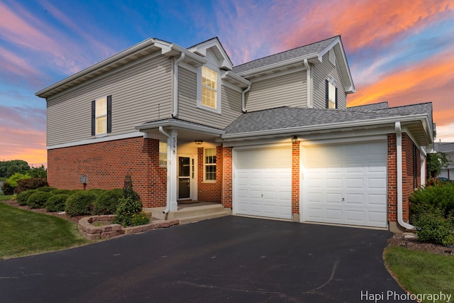 548 Legend Ln, Mchenry, IL 60050 - view of front facade featuring driveway, an attached garage, brick siding, and a shingled roof