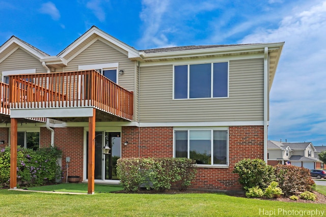 548 Legend Ln, Mchenry, IL 60050 - back of house featuring brick siding, a lawn, and a deck