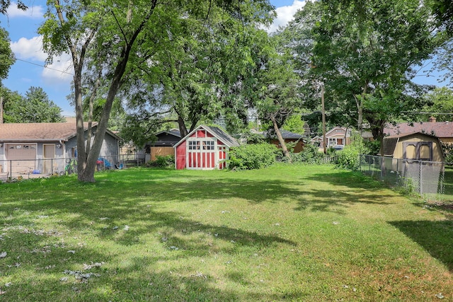 528 5th St, Aurora, IL 60505 - fenced yard featuring a storage unit and a garage