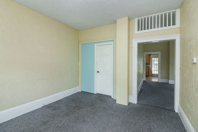 528 5th St, Aurora, IL 60505 - empty room featuring dark carpet and a textured ceiling