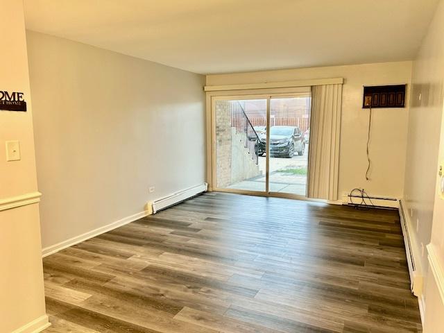 2B Dundee Quarter Unit 101, Palatine, IL 60074 - spare room with a baseboard radiator and wood finished floors