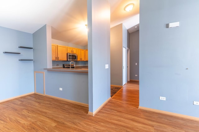 1521 Silverstone Dr Unit 3, Carpentersville, IL 60110 - kitchen featuring light wood finished floors, stainless steel microwave, and vaulted ceiling