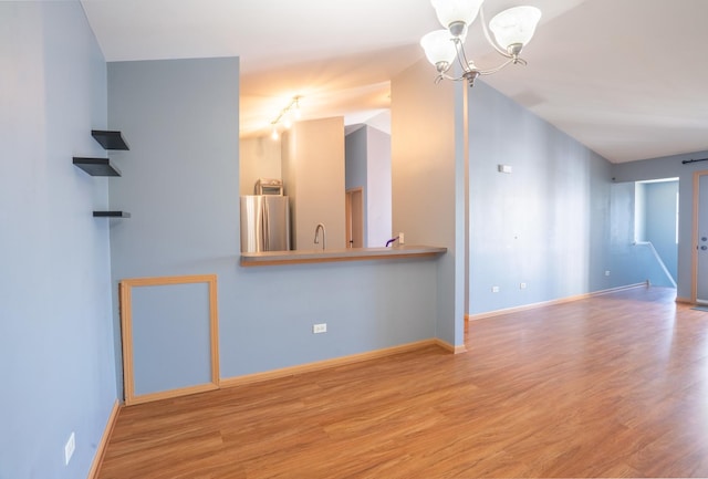 1521 Silverstone Dr Unit 3, Carpentersville, IL 60110 - empty room with a chandelier and wood finished floors