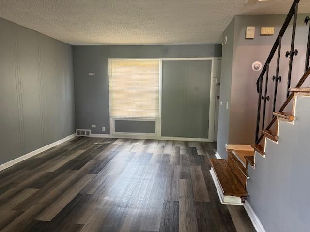 622 N Pine St, Waukegan, IL 60085 - foyer with wood finished floors, a textured ceiling, and stairway