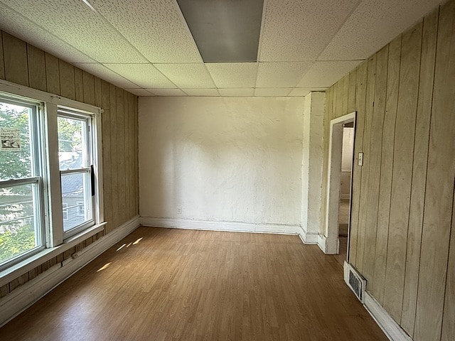 6044 S Justine St, Chicago, IL 60636 - spare room featuring wooden walls and wood finished floors