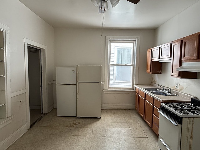 6044 S Justine St, Chicago, IL 60636 - kitchen with white appliances, under cabinet range hood, a ceiling fan, and light countertops