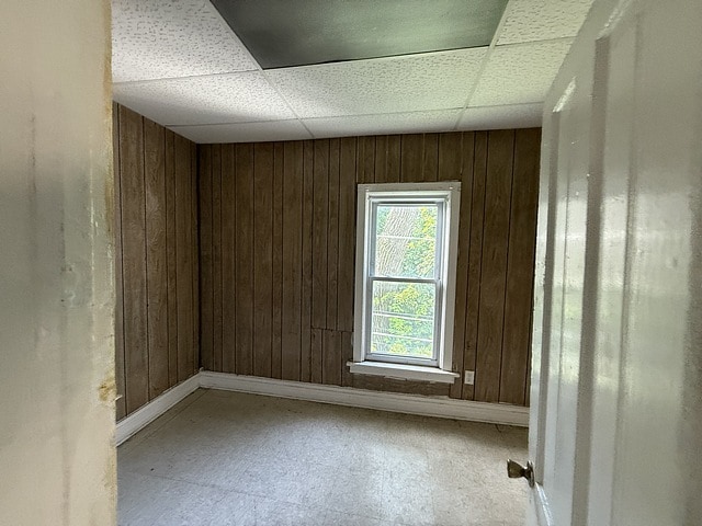 6044 S Justine St, Chicago, IL 60636 - spare room featuring wood walls and a drop ceiling
