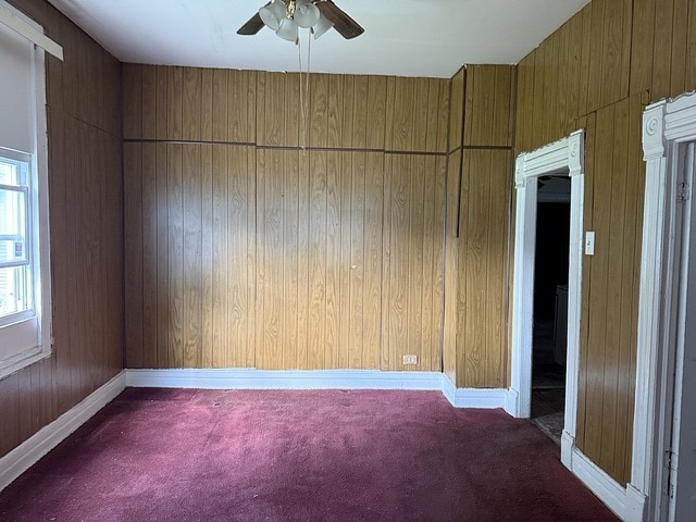 6044 S Justine St, Chicago, IL 60636 - empty room featuring carpet floors, ceiling fan, and wood walls