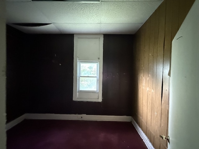 6044 S Justine St, Chicago, IL 60636 - empty room featuring wooden walls and baseboards