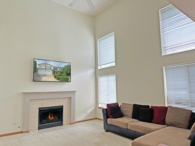 6814 Sahara Dr, Plainfield, IL 60586 - living area featuring carpet floors, a towering ceiling, a tiled fireplace, and ceiling fan