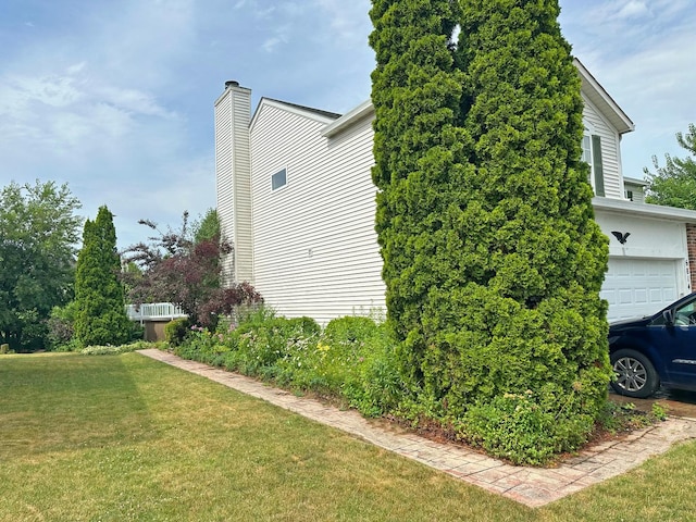 6814 Sahara Dr, Plainfield, IL 60586 - view of home's exterior featuring a lawn, a chimney, and an attached garage