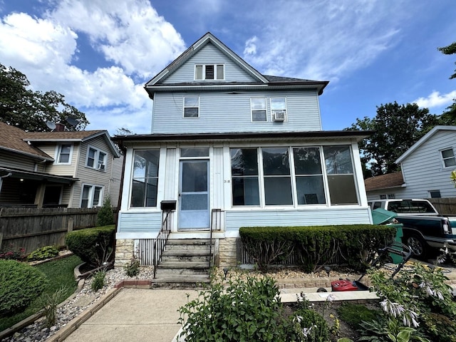 368 N Hickory St, Joliet, IL 60435 - american foursquare style home featuring entry steps, a sunroom, and cooling unit