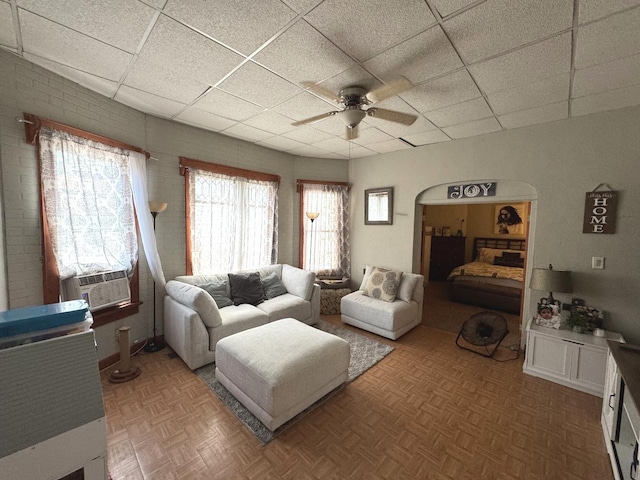 368 N Hickory St, Joliet, IL 60435 - living area with a drop ceiling, a ceiling fan, cooling unit, and arched walkways