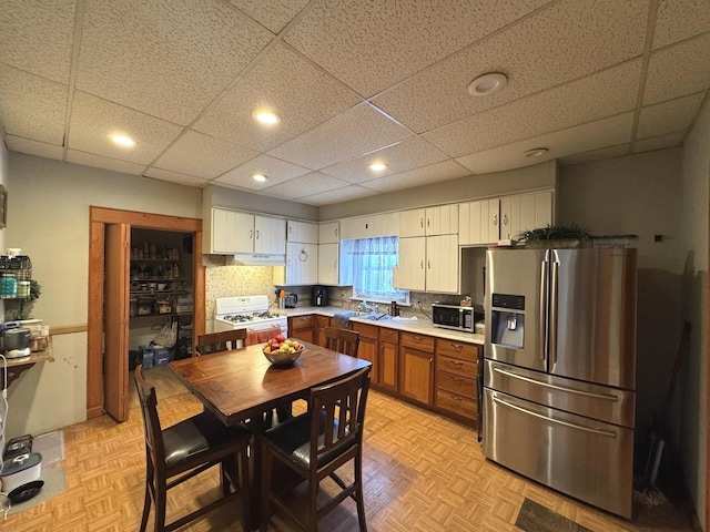 368 N Hickory St, Joliet, IL 60435 - kitchen featuring stainless steel appliances, light countertops, a drop ceiling, recessed lighting, and decorative backsplash