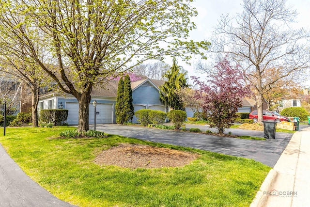 851 Sutton Ct, Lincolnshire, IL 60069 - view of property hidden behind natural elements with asphalt driveway, a front yard, and an attached garage