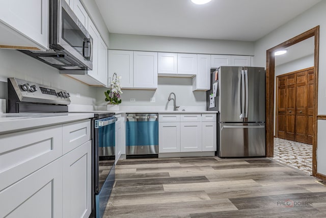 851 Sutton Ct, Lincolnshire, IL 60069 - kitchen with appliances with stainless steel finishes, white cabinets, and light countertops