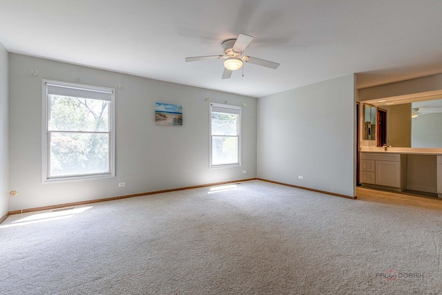 851 Sutton Ct, Lincolnshire, IL 60069 - unfurnished bedroom with light colored carpet, connected bathroom, and ceiling fan