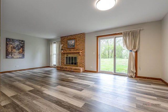 851 Sutton Ct, Lincolnshire, IL 60069 - unfurnished living room with wood finished floors and a brick fireplace