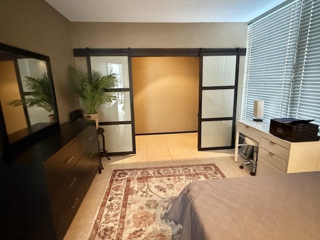 1300 N Astor St Unit 6B, Chicago, IL 60610 - bedroom featuring a barn door and light tile patterned flooring